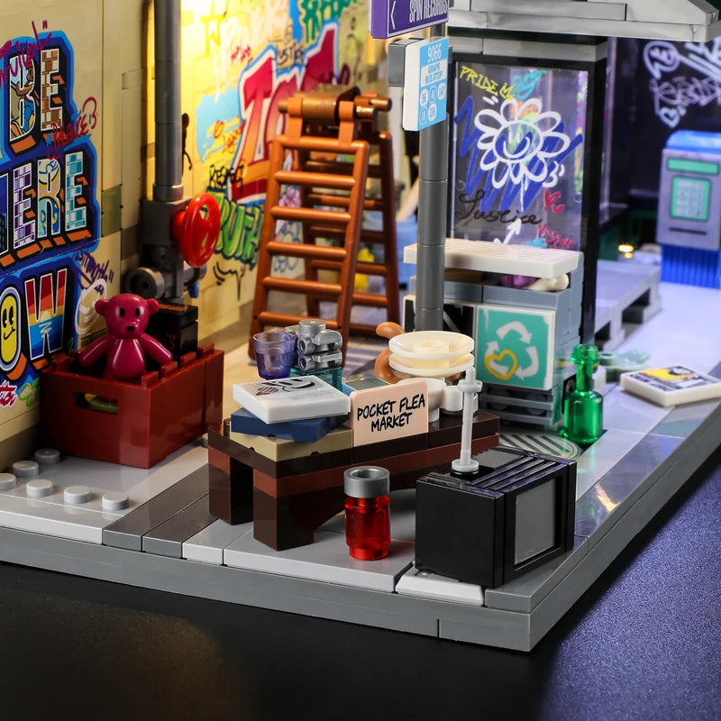 Lumibricks 19004 Graffiti Bus Stop LED glowing bulb sign and warm yellow street lamp nighttime modular display