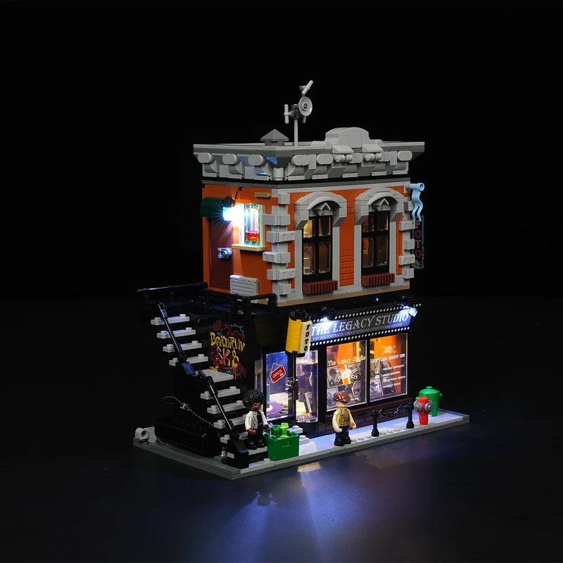 Lumibricks 19016 – side angle view of The Legacy Studio with red brick facade, LED lighting and exterior staircase