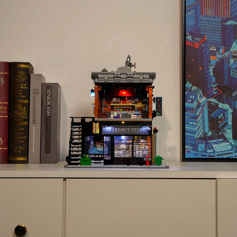 Lumibricks 19016 – lifestyle display on shelf with LED-lit interior, darkroom red light and The Legacy Studio storefront